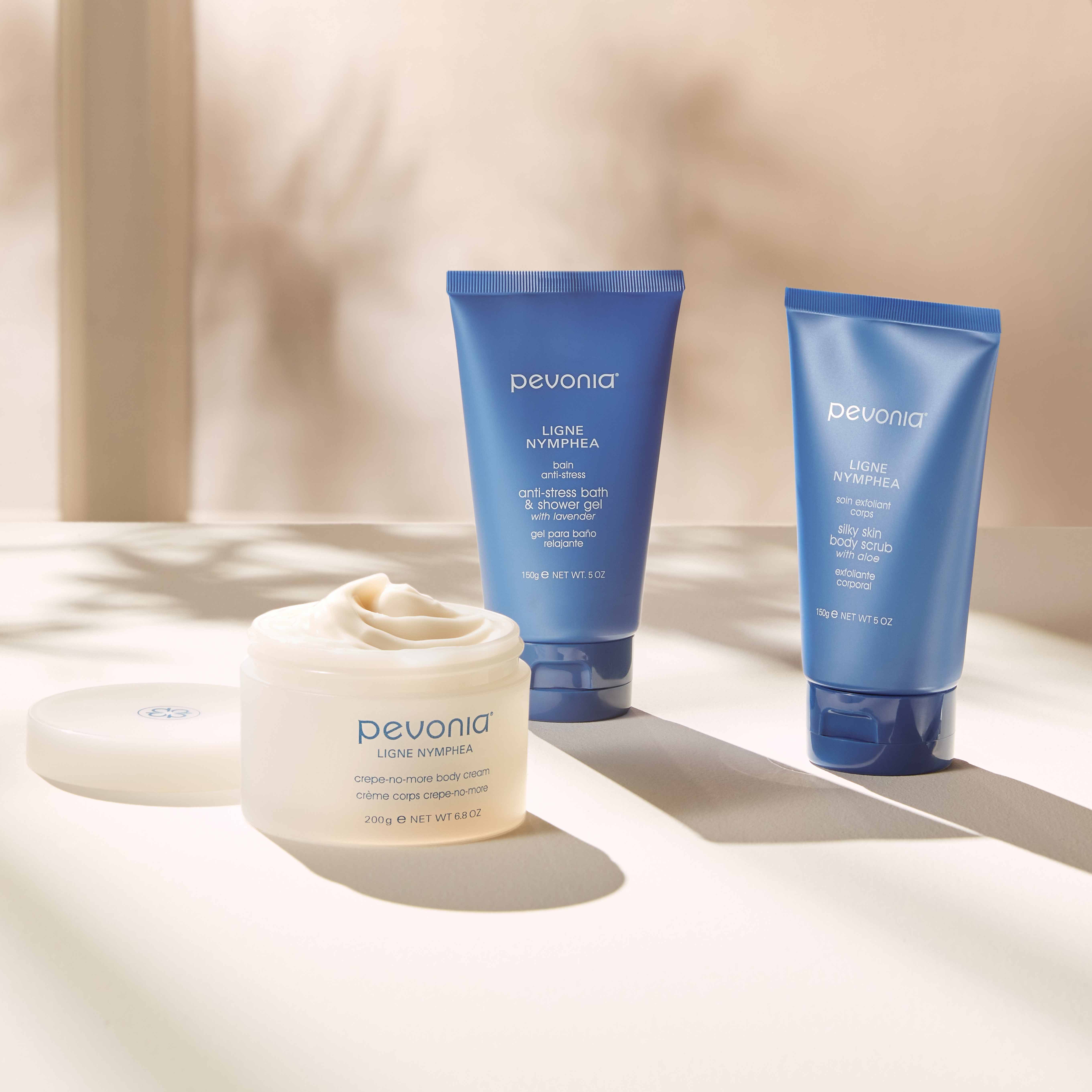Pevonia Body Line products on a soft beige background with shadows.