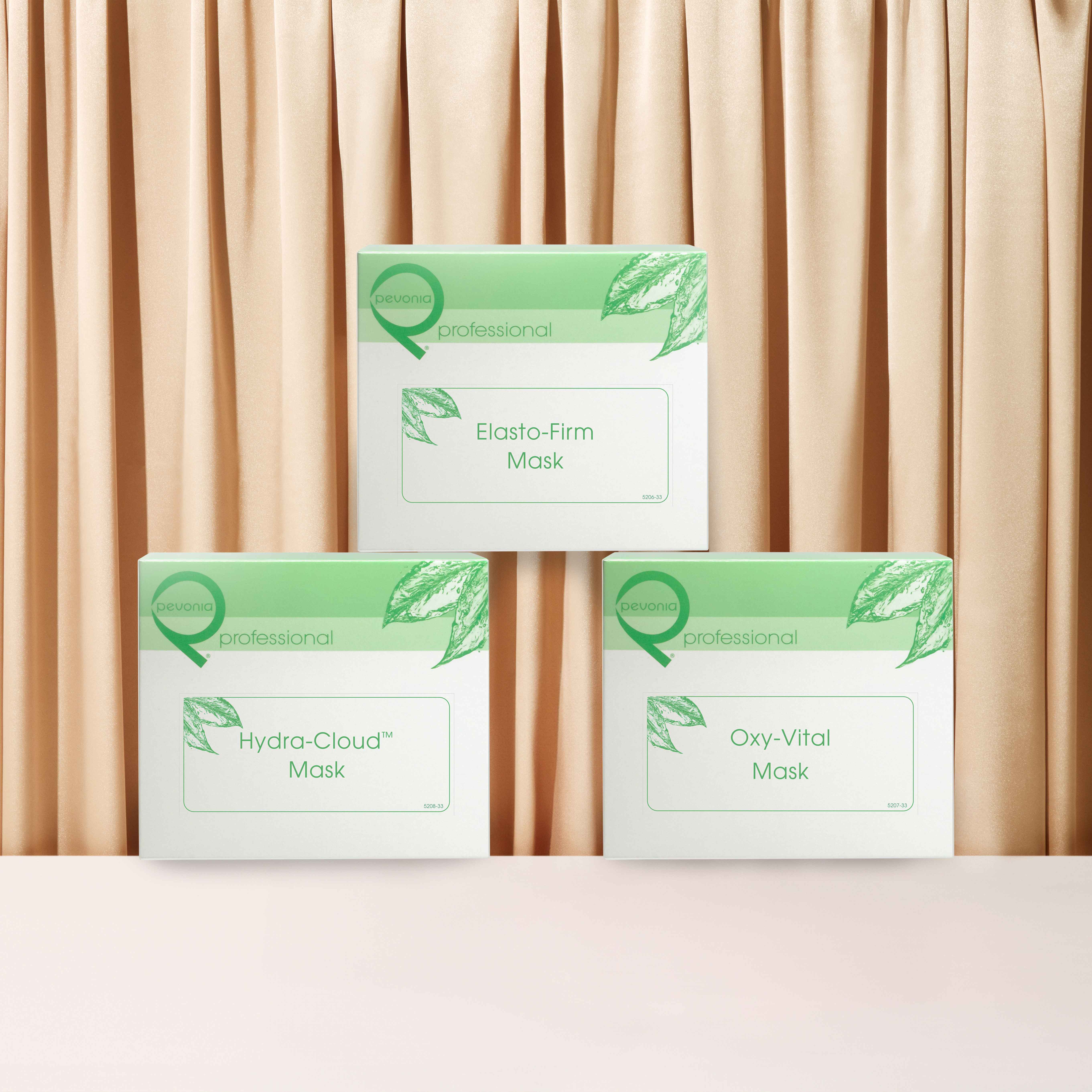 Pevonia Facial Treatment Boxes stacked in front of curtains.