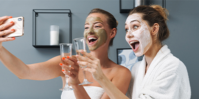 Women taking a selfie with Pevonia Radiance Line masks on.