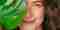 Brunette Woman Peaking Through Tropical Leaves
