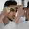 A man looking into his mirror, inspecting his Acne.