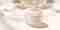 Pevonia's Crepe-No-More Body Cream with its cap off by a window, with natural light and shadows everywhere.