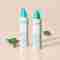 Sensitive Skin Cleanser and Lotion standing near leaves.